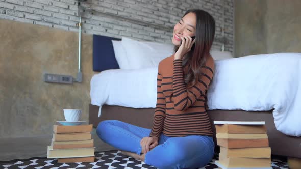 Young asian woman use smart phone in room alt