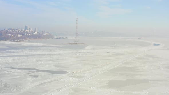 Flight Over the Frozen Sea and a Drone View of the Lighthouse alt