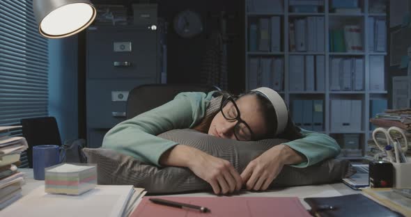 Overworked woman sleeping at her desk