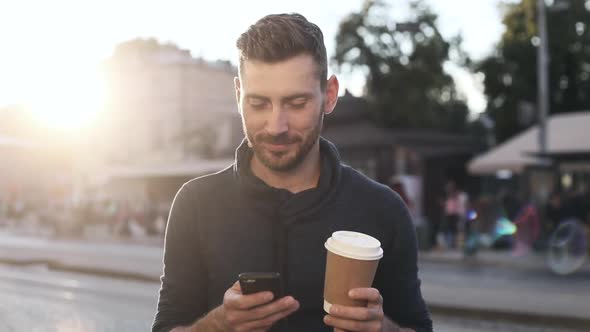 Attractive Man Walking in the City Center during the Bright Sunset. alt