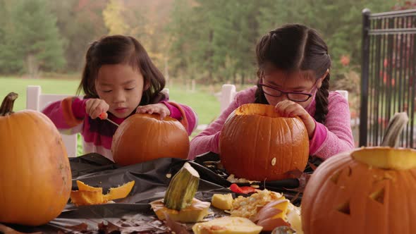 Kids carving pumpkins for Halloween