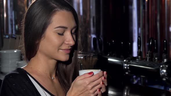 Beautiful Young Woman Smiling, Looking Away Dreamily, Enjoying Her Coffee alt