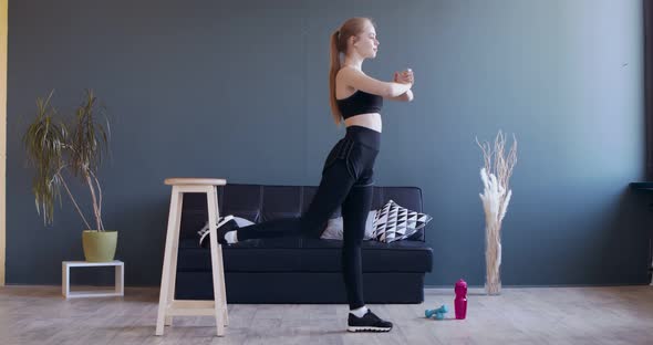 Young Girl Squatting, Keeping One Leg on Chair Behind Her alt