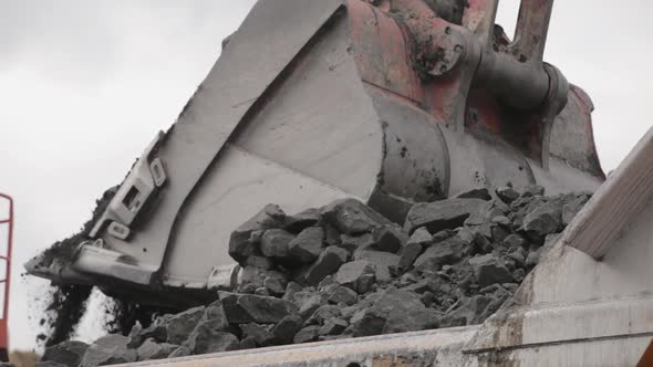 An Excavator Bucket Digs Coal