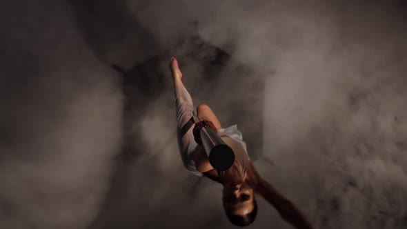 Woman Sexy Doing Pole Dance . Black Smoke Background. Top View alt