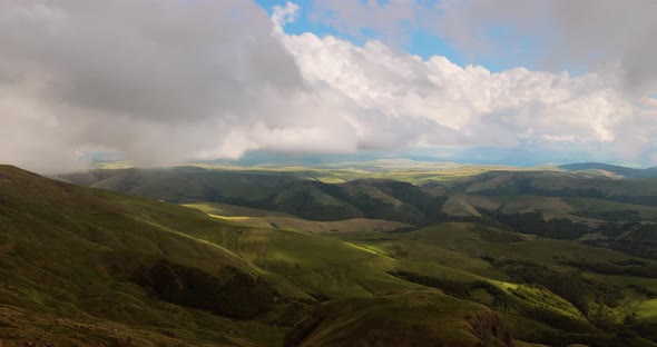 Low Clouds Over a Highland Plateau in the Rays of Sunset alt