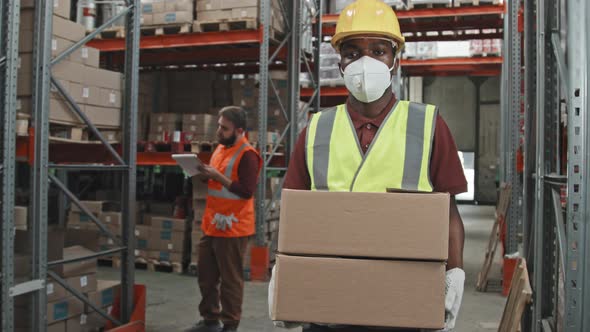 African-American Male Worker Posing in Warehouse alt