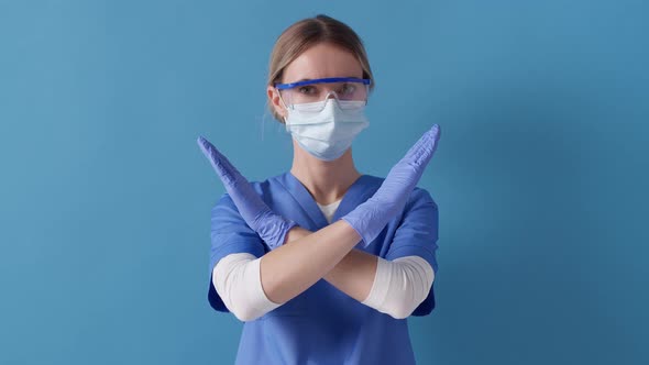 Nurse crossed her hands shows stop gesture, to control an outbreak of virus. Concept of safety life