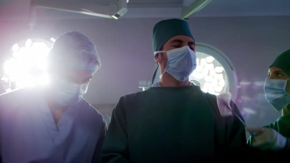 Medical team performing operation in operating room alt