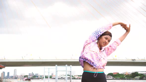 Young Asian Sportswoman Stretching Outdoors in Morning alt