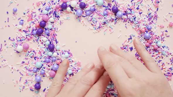 Colorful purple sprinkle blend on a pink background. alt