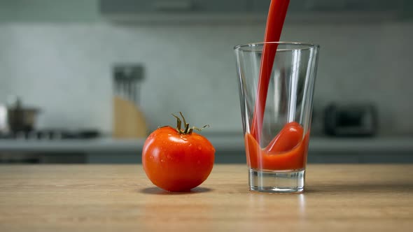 Filling glass with tomato juice. Close up shot