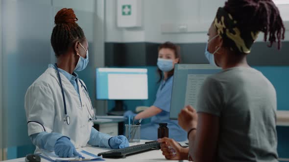 Doctor Holding x Ray Scan to Explain Bones Diagnosis to Patient alt