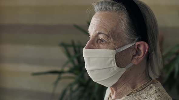 Portrait of Old Woman in Face Mask on Quarantine alt