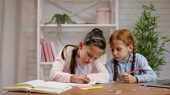 Two Little Children Girl Using Laptop for Doing School Tasks at Home