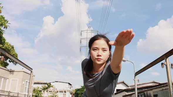 Athlete young Asian woman stretching legs and warming before running.