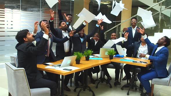 Success International Group of Ten Excited Young Business Team Throwing Away Papers and Hands Shake alt