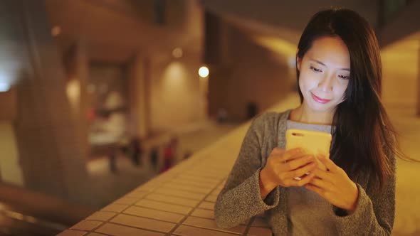 Woman use of smart phone at night  alt