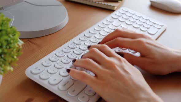 Woman typing on computer keyboard. Closeup 4k footage