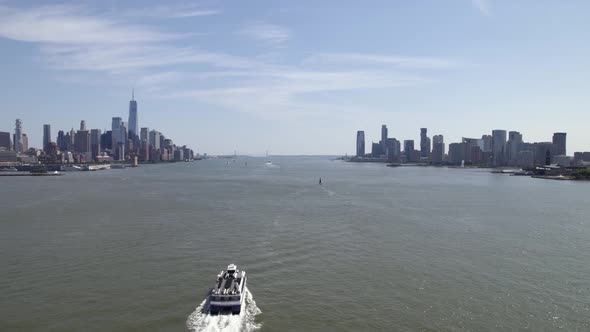 Revealing a ferry on Hudson river, summer in sunny New York, USA - Reverse Aerial alt
