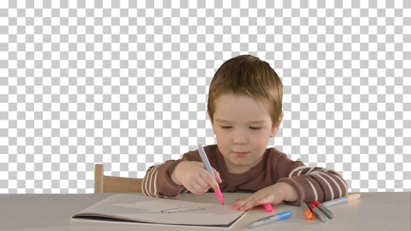 A son drawing at the table at home, Alpha Channel