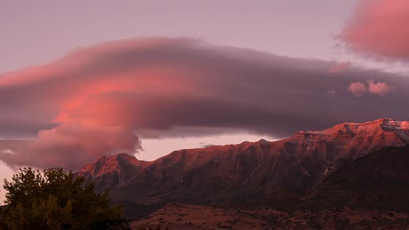 Lenticular clouds during colorful sunset over Timpanogos Mountain alt