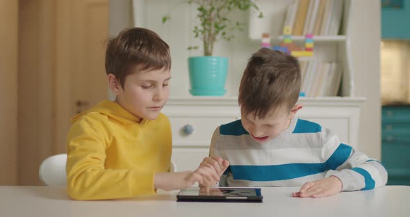 Two Boys with Autism Using One Tablet Computer for Education Application alt