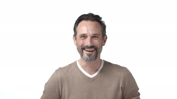 Slowmotion Handsome Confident Businessman with Grey Beard Starts Laughing Happy Looking Camera alt
