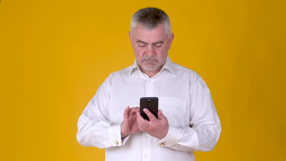 Handsome adult man uses smartphone texting messages in social media
