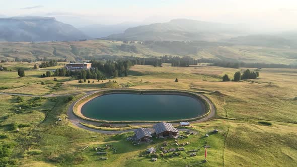 Dolomites mountains peaks with a hiking path on a summer sunrise alt
