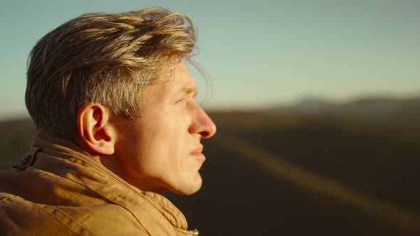 Close Up Portrait Man Hikert on Beautiful Mountains Background at Sunset Enjoys Amazing Calm Forest alt