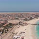 Aerial footage of the famous pier at Cape Verde, fishermen with fishermen's wives selling the fish