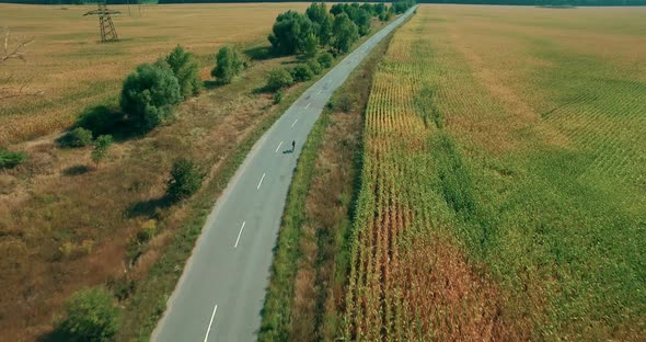 Aerial Cycling Fitness Training On Carbon Bike. Drone Cyclist Cardio Exercise On ITT Bike. alt