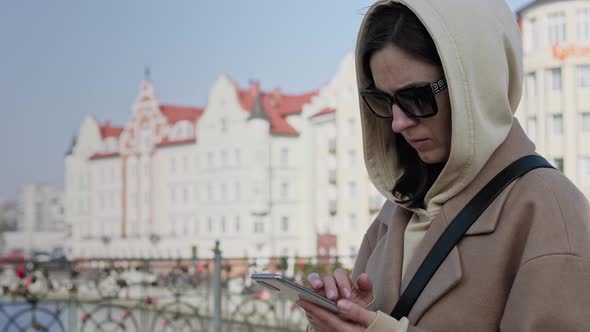Young woman with smartphone in an urban city area