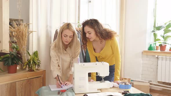 Caucasian Fashion Designers of Clothes Young Women Have Talk About Color and Shape Dress Sewing