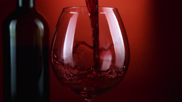 Super Slow Motion Shot of Pouring Red Wine From Bottle with Camera Rotation at 1000Fps. alt