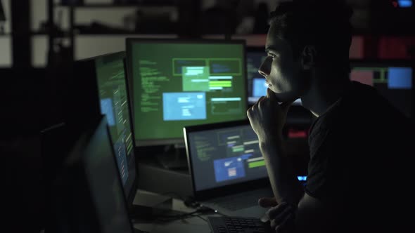 Developer working late at night and hacking networks