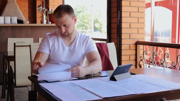 Construction engineers checks the blueprints of the business center. alt