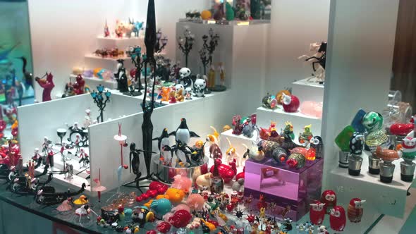 Indoor Shoot of a Souveniers, Figurines and Accessories on a Stand. Lots of Different Glass-made