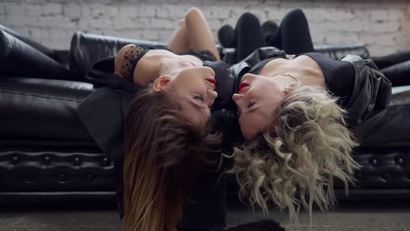 Loving Female LGBT Couple Lying Upside Down on Couch Looking at Each Other alt