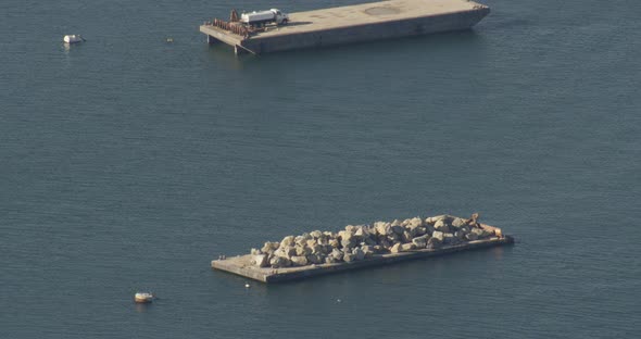 Aerial overhead helicopter shot, tracking above rural Alaskan airstrip, hanger, snow covered heavy m alt