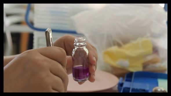 The researcher put a pieces of meat samples into a test bottle.