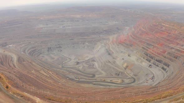 Aerial View of Opencast Mining Quarry with Lots of Machinery at Work