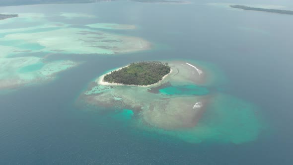Aerial: flying over tropical island white beach caribbean sea turquoise water co alt