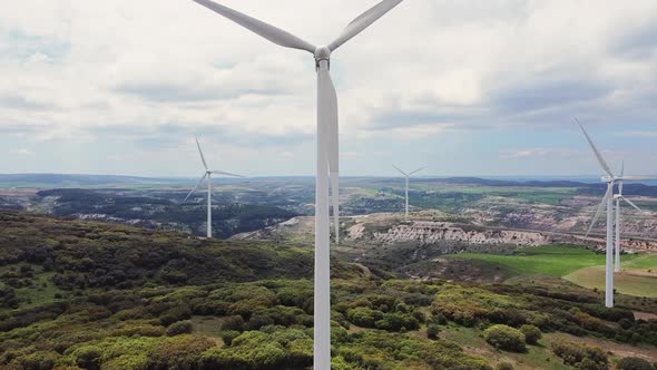 Aerial View of Windmills Farm for Clean Energy Production on Beautiful Cloudy Sky. Wind Power alt