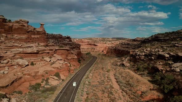 Drone view of road in desert with traffic near Moab