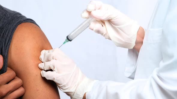 Arm of a Man Getting a Vaccine