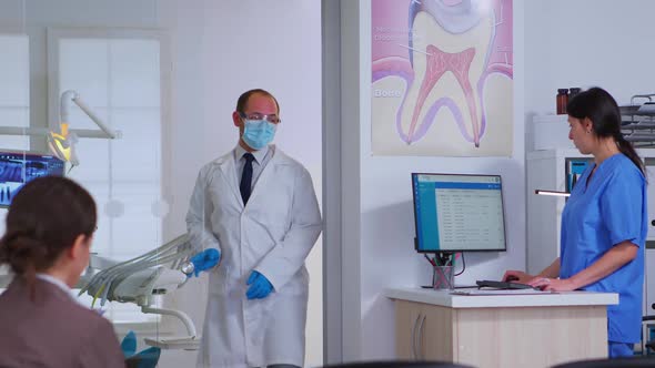 Professional Doctor Asking for Dental Xray Before Examining Patient alt