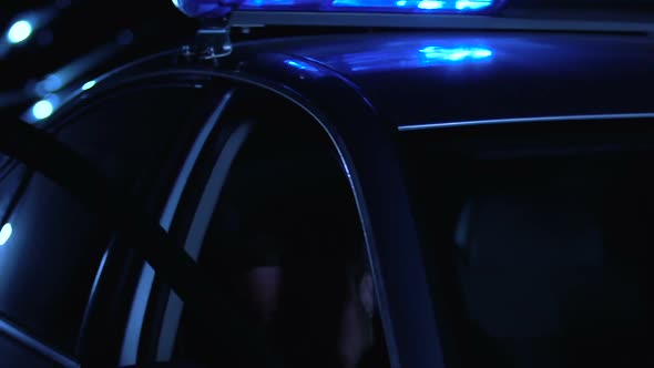 Patrolman Getting Out of Car and Aiming Pistol at Perpetrator, Law and Order alt