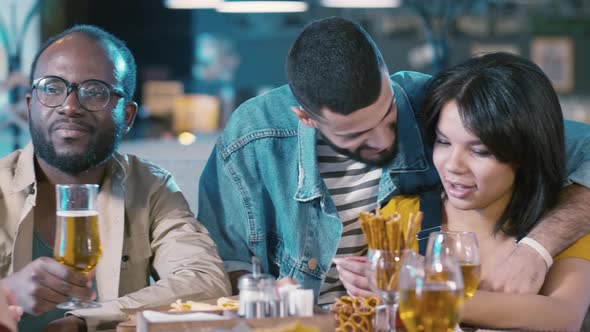 Group of friends spending time in bar